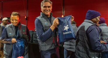 a man with sasol logo holds up a bag