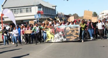 a group of people march in the street