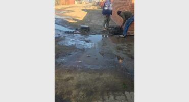 a man repairs a water leak in the street