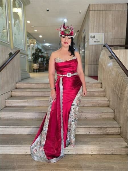 a curvy woman in a red dress and hat