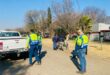 People in uniforms patrol the road
