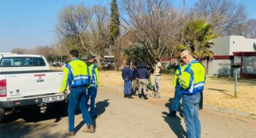 People in uniforms patrol the road
