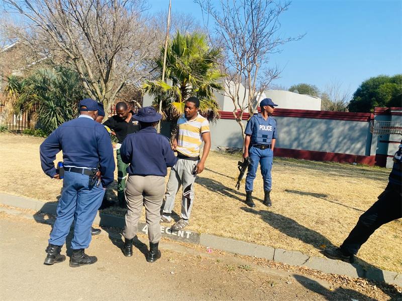 People in uniforms patrol the road