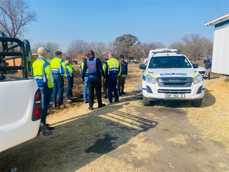 People in uniforms patrol the road