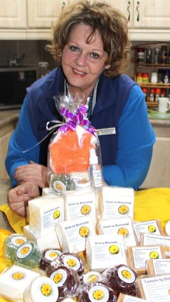 a woman with numerous products in front of her