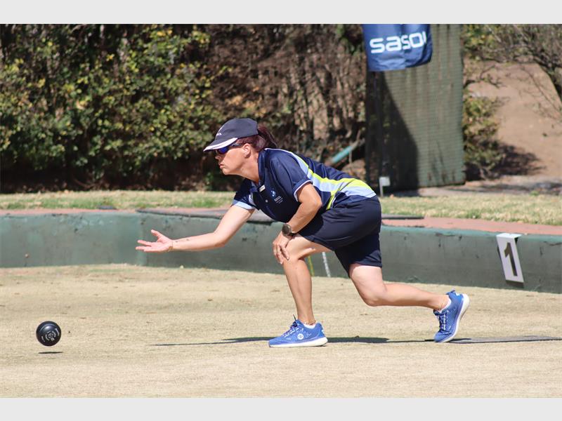 A woman playing bowls