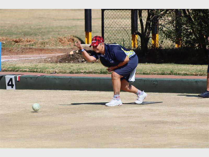 A woman playing bowls