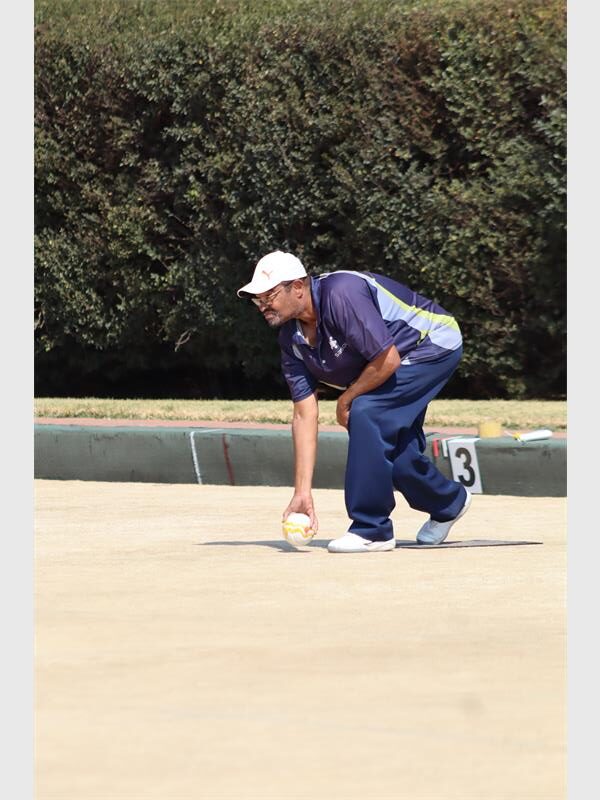 man in blue playing bowls