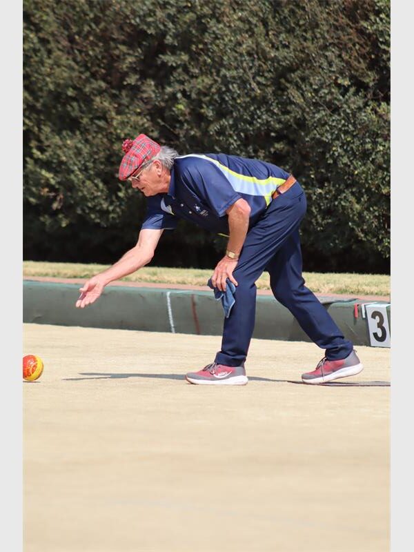 man in blue playing bowls