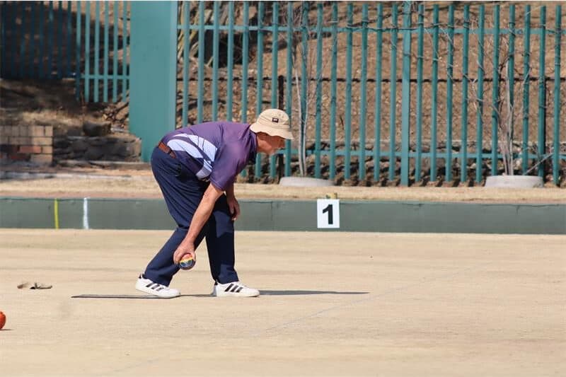 man in blue playing bowls