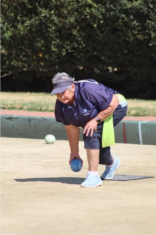 A woman playing bowls