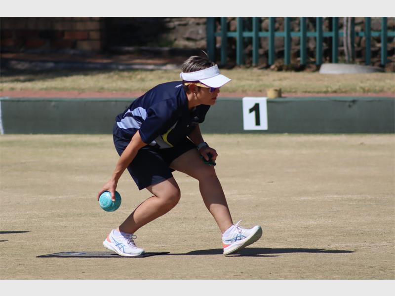 A woman playing bowls
