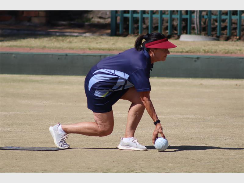 A woman playing bowls
