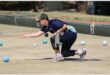 A woman playing bowls