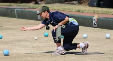A woman playing bowls