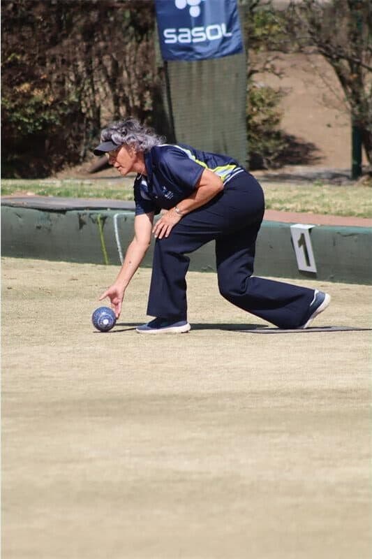 A woman playing bowls