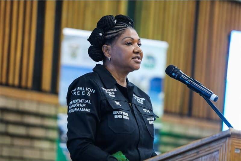 A woman speaks from a podium