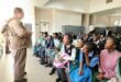 a prison warden is speaking to young people