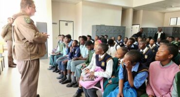 a prison warden is speaking to young people
