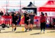 men race with heavy bags on their shoulders