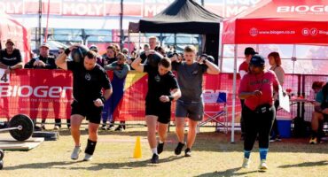 men race with heavy bags on their shoulders