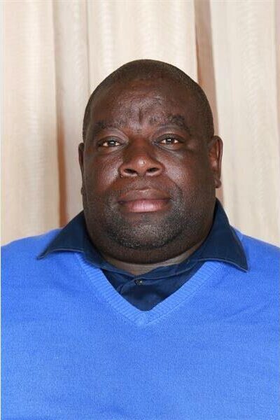 head and shoulder photo of a man in a blue jersey