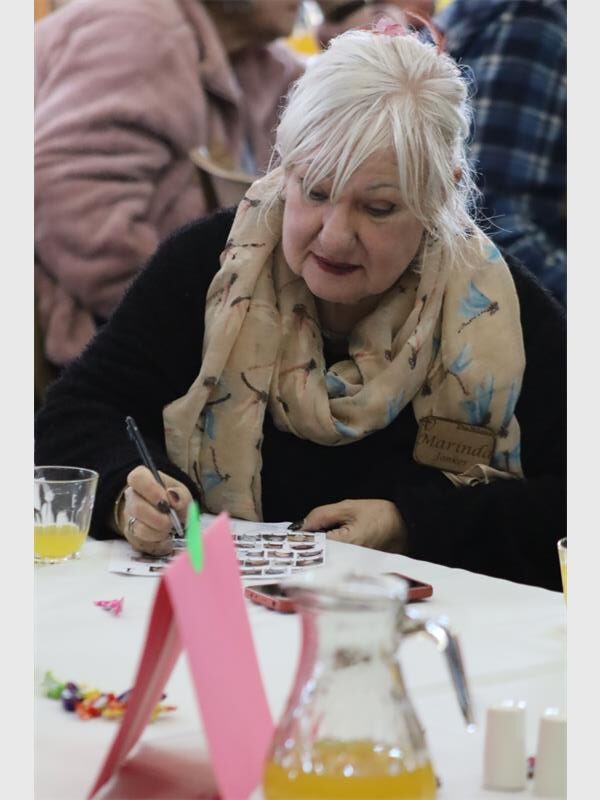 A woman stare at a a page with photos