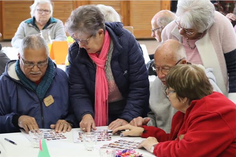 a group discuss a page with photos