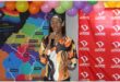 A person standing in front of colourful maps and balloons