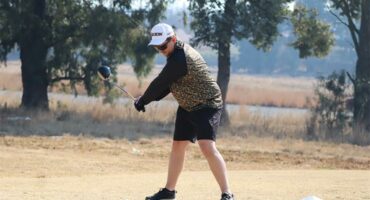 a man in short pants plays golf