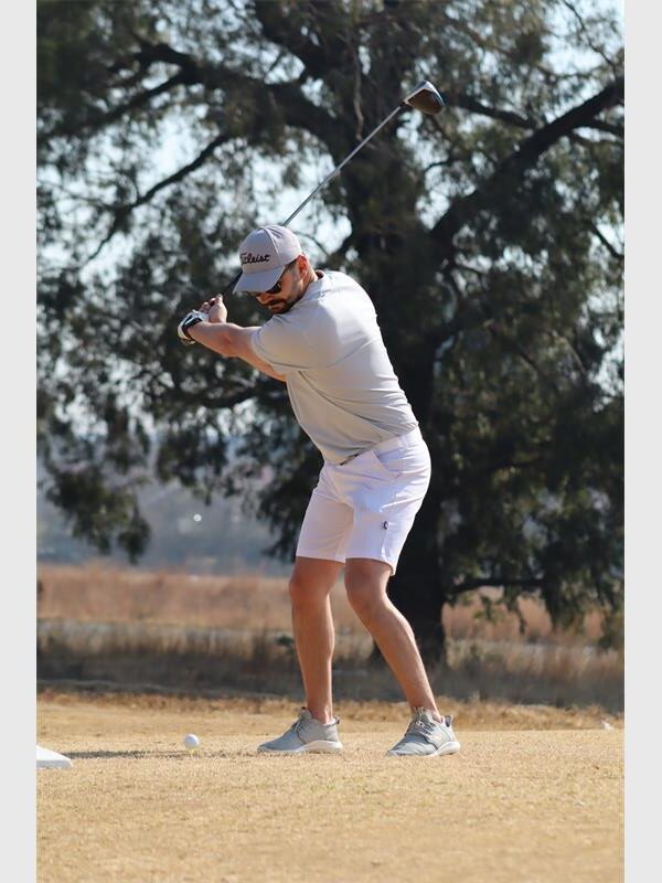 a man in short pants plays golf