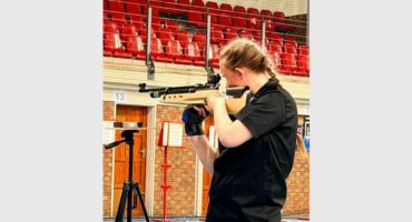 a girl aims to shoot at a target