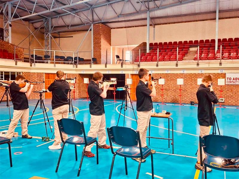 kids shooting at targets in a hall