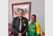 a teacher with a tie and a girl in SA colours
