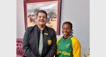 a teacher with a tie and a girl in SA colours