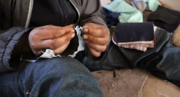 a homeless woman does sewing