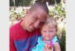 a man hold n little girl in his arms