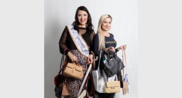 two beautiful women with handbags
