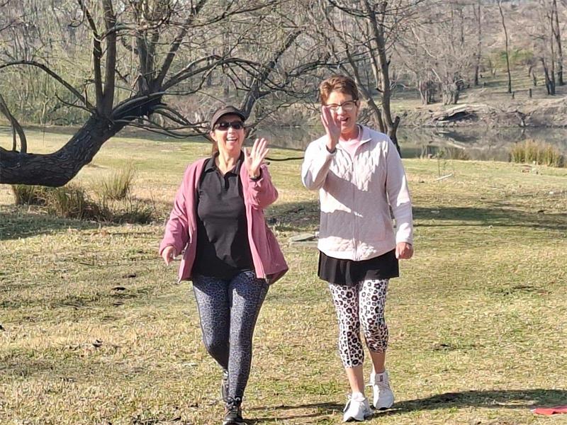 two women walking in the park