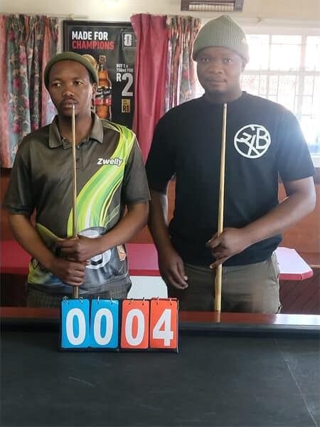 two men standing at a pool table