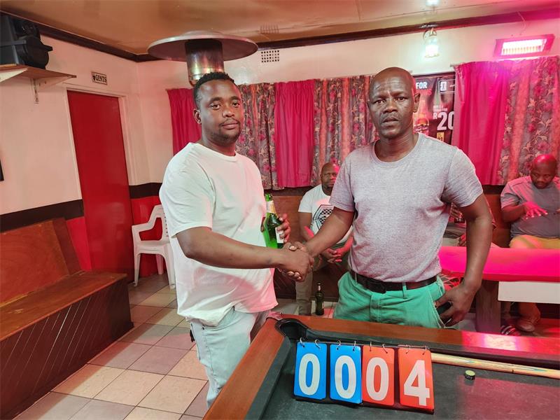 Two men at a pool table