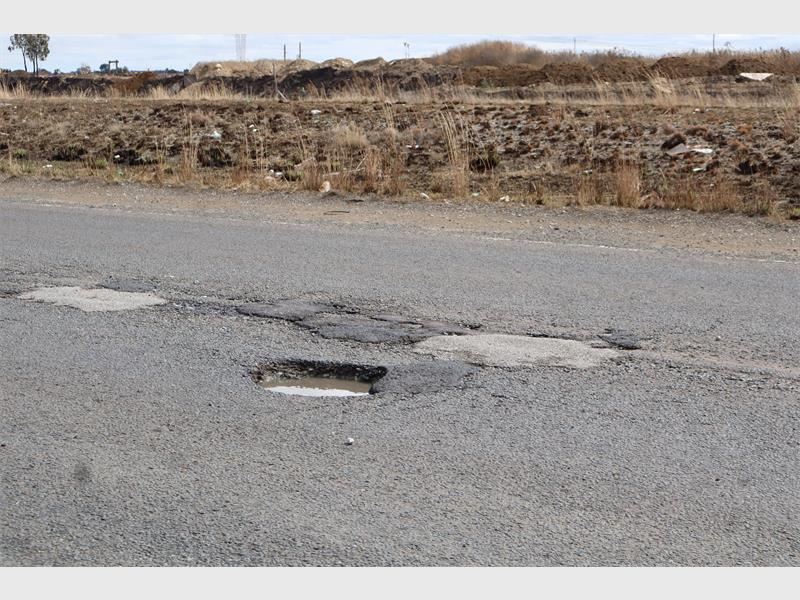 a road riddled with potholes