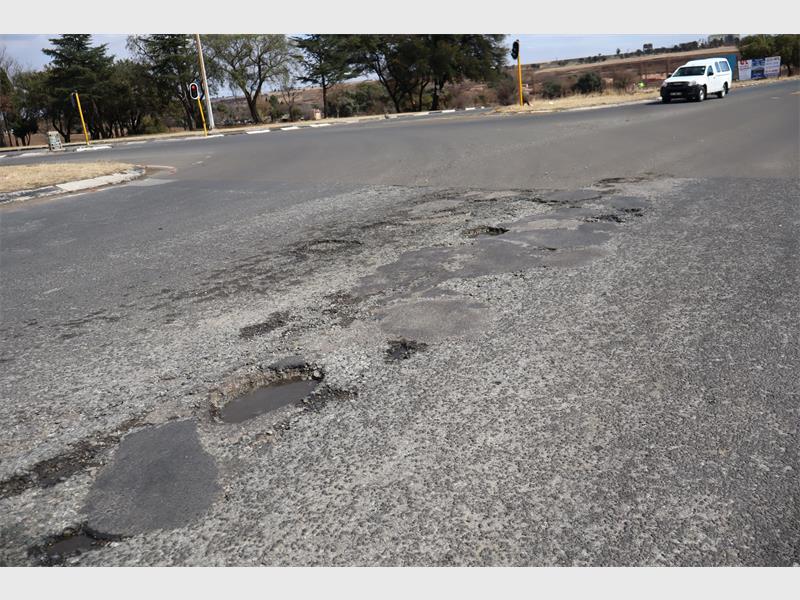 a road riddled with potholes