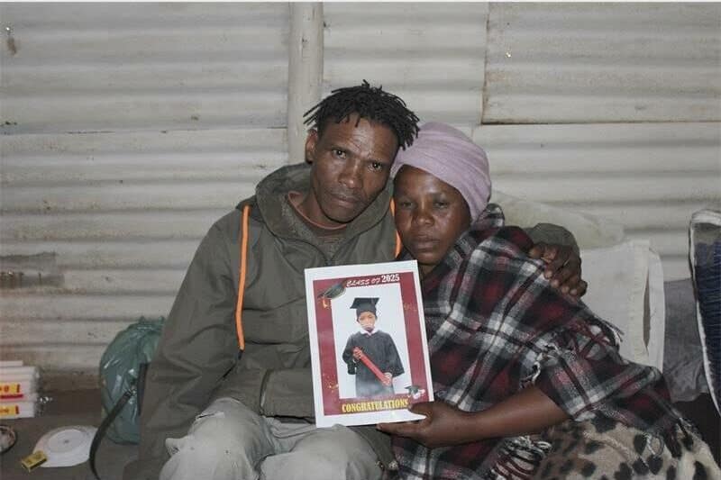 parents holding the photo of their daughter
