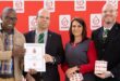 Four people with certificates from the national blood services