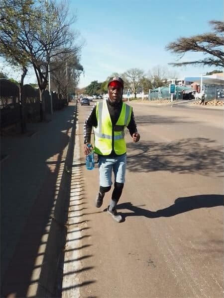 a man running in a reflector jacket