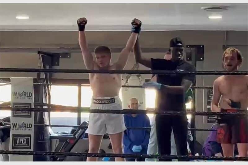 Boxing ref holds up the winner's arm