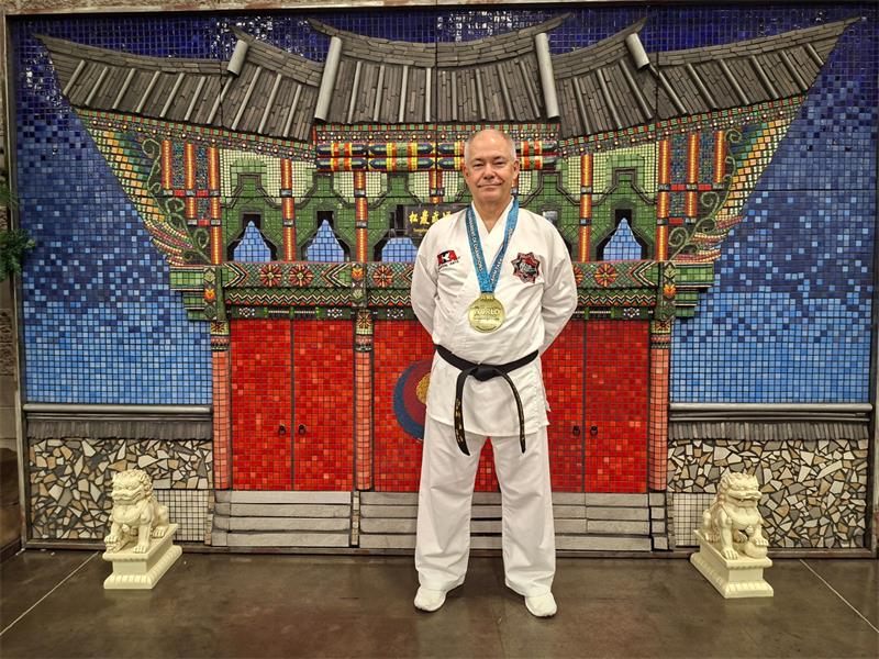 man in martial arts suit and black bbelt