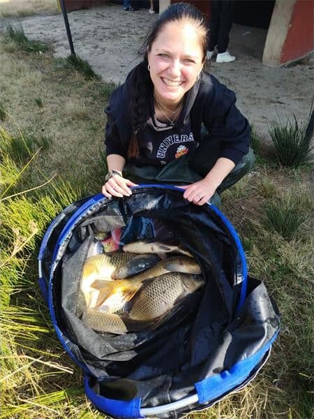 woman shows off her bag of fish