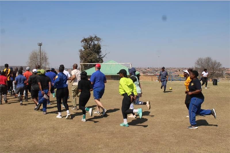 a group of people exercising on a soccer field